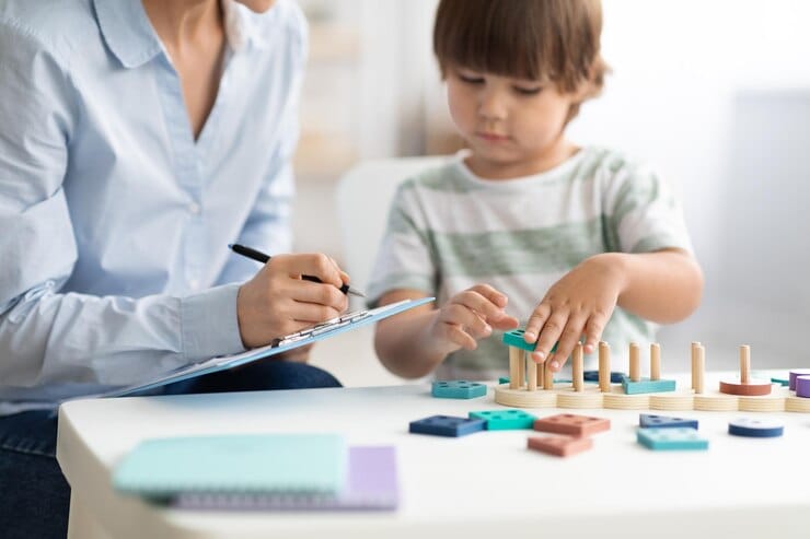 Therapist using CBT worksheets with child